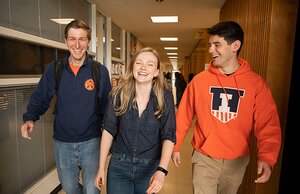Three students walk down the hall in the Education Building.