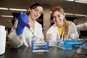 Female students work together in a laboratory.