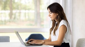 Woman typing on a computer