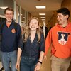 Three students walk down the hall in the Education Building.