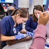 nurse is training on how to put in an IV